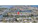 Aerial view of waterfront property with a private boat dock, nestled among homes and canals at 13614 Evelane Dr, Hudson, FL 34667