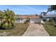 Charming single-story home featuring an attached two-car garage and a well-maintained front yard at 13614 Evelane Dr, Hudson, FL 34667