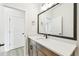 Bathroom with sleek vanity, quartz countertop, modern mirror and stylish fixtures at 28784 Rambutan Dr, Wesley Chapel, FL 33543