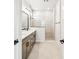 Modern bathroom with double vanity, tiled shower with glass door, and neutral color scheme at 28784 Rambutan Dr, Wesley Chapel, FL 33543