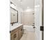 Bathroom featuring a shower over bath, sleek vanity, modern fixtures and a large mirror at 28784 Rambutan Dr, Wesley Chapel, FL 33543