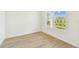 Bright, airy bedroom with a large window and light wood flooring at 28784 Rambutan Dr, Wesley Chapel, FL 33543