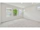Carpeted bedroom with three windows and recessed lighting providing ample natural light at 28784 Rambutan Dr, Wesley Chapel, FL 33543