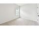 Bright, neutral bedroom with soft carpet and a window offers a blank canvas for personalization and comfort at 28784 Rambutan Dr, Wesley Chapel, FL 33543