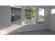 Bright bedroom with multiple windows offering natural light and views of the front yard at 28784 Rambutan Dr, Wesley Chapel, FL 33543