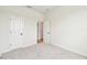 Clean, well-lit bedroom with neutral carpet and an ensuite bathroom offers a private and comfortable space at 28784 Rambutan Dr, Wesley Chapel, FL 33543