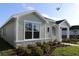 Well-maintained single-story home with stone accents, a covered entry, and manicured landscaping at 28784 Rambutan Dr, Wesley Chapel, FL 33543