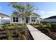 Charming single-story home with a landscaped front yard and a welcoming walkway to the front door at 28784 Rambutan Dr, Wesley Chapel, FL 33543