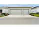 Two-car detached garage featuring light-colored paint with a driveway extending out to the street at 28784 Rambutan Dr, Wesley Chapel, FL 33543