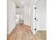 Bright hallway with light wood floors connecting various rooms within the home at 28784 Rambutan Dr, Wesley Chapel, FL 33543
