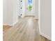 View of a hallway featuring modern door and light wood flooring at 28784 Rambutan Dr, Wesley Chapel, FL 33543