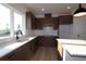 Bright kitchen featuring stainless steel appliances, a modern faucet, wooden cabinets and quartz countertop at 28784 Rambutan Dr, Wesley Chapel, FL 33543