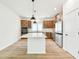 Modern kitchen featuring stainless steel appliances, a large island, and stylish pendant lighting at 28784 Rambutan Dr, Wesley Chapel, FL 33543