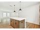 Open-concept kitchen with large island offering seating and views of the living space at 28784 Rambutan Dr, Wesley Chapel, FL 33543