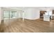 Spacious open-concept living area with modern wood flooring and sliding glass doors leading to an outdoor space at 28784 Rambutan Dr, Wesley Chapel, FL 33543