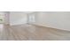 Open living room with light-colored floors and white walls with two windows providing natural light at 28784 Rambutan Dr, Wesley Chapel, FL 33543