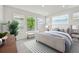 Main bedroom area featuring lots of bright windows, a bed, sofa and decorations at 28784 Rambutan Dr, Wesley Chapel, FL 33543