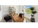 Home office with a large bright window, shelving, desk and chair, and a plant at 28784 Rambutan Dr, Wesley Chapel, FL 33543