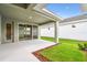 An open patio featuring mulch and a patch of grass separating the patio from the home at 28784 Rambutan Dr, Wesley Chapel, FL 33543