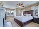 Spacious bedroom features a decorative fireplace, fan, and large windows providing ample natural light at 302 49Th N St, St Petersburg, FL 33710