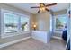 Bright bedroom with large windows, ceiling fan, and a white dresser for ample storage space at 302 49Th N St, St Petersburg, FL 33710