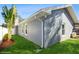 Exterior view of a gray home with well-maintained lawn and white trim around windows and roof at 3053 Glenwood Ct, Safety Harbor, FL 34695