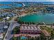 Aerial view showcasing the neighborhood, waterfront access, the intracoastal, nearby buildings and beautiful canals at 3390 W Maritana Dr # 4, St Pete Beach, FL 33706