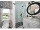 Cozy bathroom with a modern vanity, stylish mirror, and walk-in shower at 3390 W Maritana Dr # 4, St Pete Beach, FL 33706