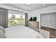 Bright bedroom with view and featuring a comfortable bed and modern furnishings at 3390 W Maritana Dr # 4, St Pete Beach, FL 33706