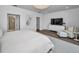 Bright bedroom with a white color palette, modern furniture, wood floors, and natural light at 3390 W Maritana Dr # 4, St Pete Beach, FL 33706