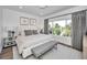 Well-lit bedroom with a serene view, featuring a plush bed and stylish curtains at 3390 W Maritana Dr # 4, St Pete Beach, FL 33706
