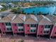 Charming residential building featuring unique architectural details, a red brick driveway and lush landscaping at 3390 W Maritana Dr # 4, St Pete Beach, FL 33706