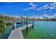 Waterfront property featuring a private dock with boat lift, offering direct access to the open water and stunning views at 3390 W Maritana Dr # 4, St Pete Beach, FL 33706