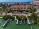 Waterfront property with boat docks and a charming multi-story building, showcasing coastal living and easy access to the water at 3390 W Maritana Dr # 4, St Pete Beach, FL 33706