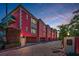 Unique pink exterior of townhomes with arched details, covered parking, and brick driveway at 3390 W Maritana Dr # 4, St Pete Beach, FL 33706