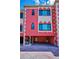Close up view of pink townhomes with garage entries, architectural details, and unit numbers at 3390 W Maritana Dr # 4, St Pete Beach, FL 33706