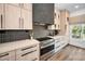 Well-appointed kitchen with stainless steel appliances, neutral countertops, and modern backsplash tiles at 3390 W Maritana Dr # 4, St Pete Beach, FL 33706