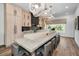 Well-lit kitchen with modern appliances, a spacious island with seating, and stylish pendant lighting at 3390 W Maritana Dr # 4, St Pete Beach, FL 33706