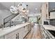 Modern open-concept kitchen with island, sleek countertops, and stainless steel appliances, flowing into the living area at 3390 W Maritana Dr # 4, St Pete Beach, FL 33706