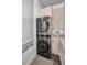 Convenient laundry room with stacked washer and dryer unit and ample storage cabinets at 3390 W Maritana Dr # 4, St Pete Beach, FL 33706