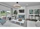 Bright living room with a marble fireplace, modern lighting, and balcony access at 3390 W Maritana Dr # 4, St Pete Beach, FL 33706