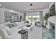 Stylish living room featuring a plush sectional sofa, statement lighting, and water views at 3390 W Maritana Dr # 4, St Pete Beach, FL 33706