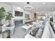 Open-concept living room with a fireplace, comfortable seating, and modern design elements at 3390 W Maritana Dr # 4, St Pete Beach, FL 33706