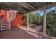 Inviting outdoor space with a spiral staircase, stone columns, and tropical plants at 3390 W Maritana Dr # 4, St Pete Beach, FL 33706
