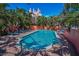 Inviting in-ground pool surrounded by a brick patio, palm trees, and lounge chairs, perfect for outdoor enjoyment at 3390 W Maritana Dr # 4, St Pete Beach, FL 33706