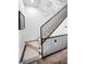Elegant staircase with modern railings, carpeted steps, and eye-catching wall decor at 3390 W Maritana Dr # 4, St Pete Beach, FL 33706