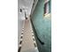 Modern carpeted stairway with stylish lighting and unique textured wallpaper at 3390 W Maritana Dr # 4, St Pete Beach, FL 33706