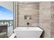 Spa-like bathroom boasts a soaking tub, modern fixtures, and city views from balcony at 5120 Marina Way # 15006, Tampa, FL 33611