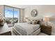 Bedroom featuring a large bed, stylish decor, and balcony access with city views at 5120 Marina Way # 15006, Tampa, FL 33611