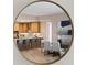 View of the open kitchen with a breakfast bar reflected in a circular mirror in the dining room at 5120 Marina Way # 15006, Tampa, FL 33611